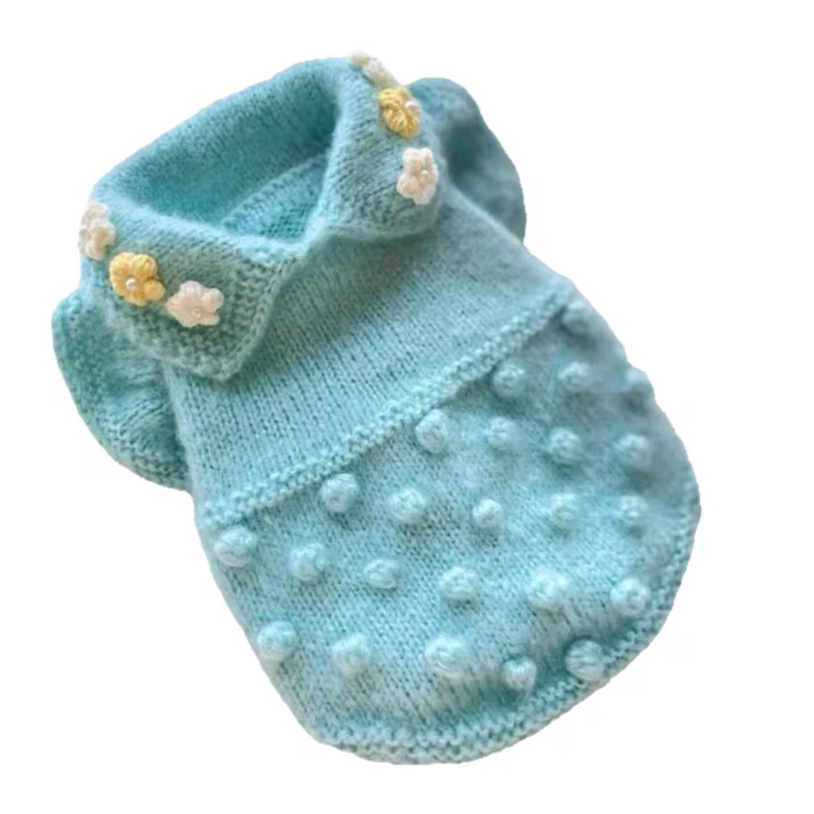 A light blue knitted pet sweater with a textured pom-pom pattern and small decorative flower embellishments, shown on a plain white background.