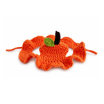 An orange crocheted pumpkin-shaped headband with a small green leaf and black stem detail, shown on a plain white background.