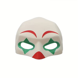 A white clown-style mask with red eyebrows and mouth details, and green diamond-shaped eye cutouts, shown on a plain white background.