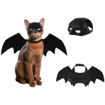 Cat wearing a black bat costume with additional wings and mask on a white background