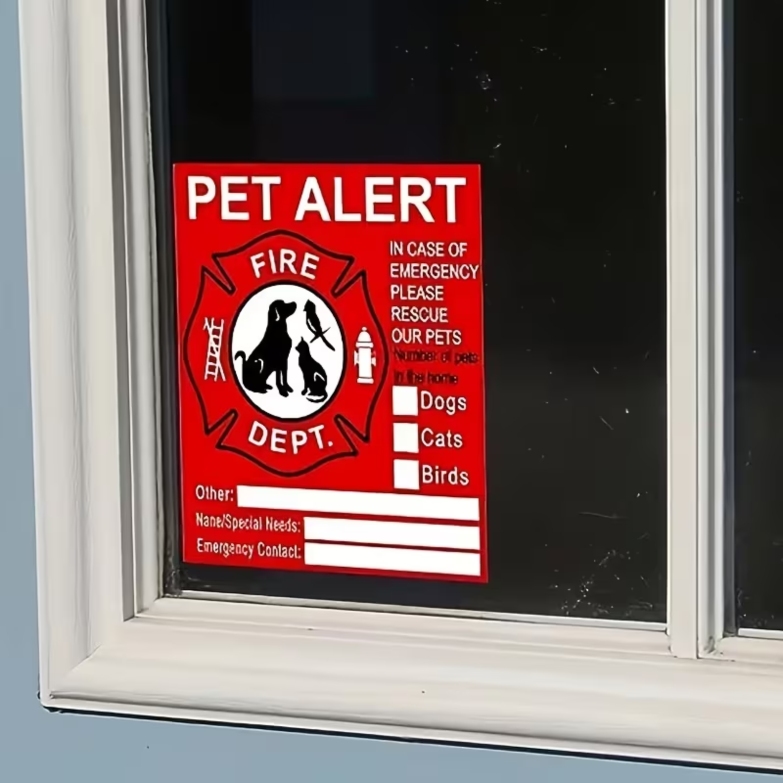 A red and white 'PET ALERT' window sign with a fire department-style emblem, shown attached to a dark window pane.