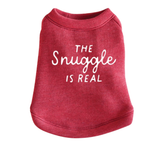 A heathered red dog sweatshirt featuring the phrase 'THE Snuggle IS REAL' printed in white across the front, shown against a plain white background.