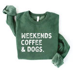 A dark green crewneck sweatshirt with the text 'WEEKENDS COFFEE & DOGS.' printed in white distressed lettering across the chest, laid flat on a white background.