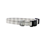 Grey and white checkered cat collar with a black buckle on a white background.