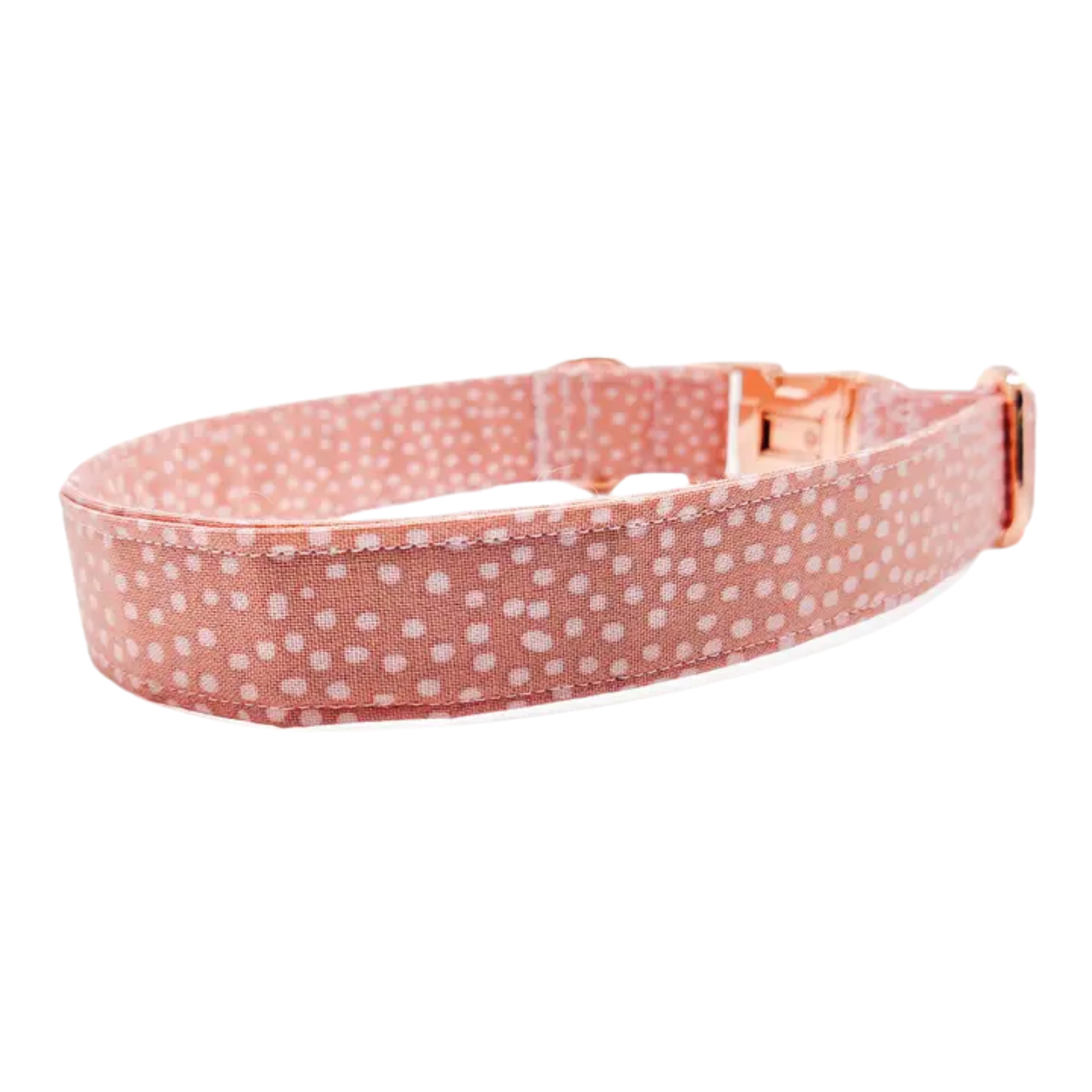 A pink fabric dog collar with a light pink polka dot pattern and a rose gold metal buckle, shown on a plain white background.