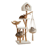 A tall multi-level cat tree with natural wood posts, cream carpeted platforms and house, woven basket perches, and a hanging macrame hammock, shown on a white background with four cats resting on different parts of the tree.