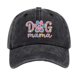 A dark gray acid-wash baseball cap featuring a colorful embroidered design on the front that reads 'DOG mama' with a paw print motif, shown against a plain white background.