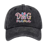 A dark gray acid-wash baseball cap featuring a colorful embroidered design on the front that reads 'DOG mama' with a paw print motif, shown against a plain white background.