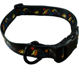 A black dog collar with a colorful mountain and campfire pattern, featuring a black plastic buckle and a black metal ring.