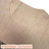 Close-up of a knit fabric garment showing a textured beige crew neck with a printed flat design underneath, labeled 'Printed Design - Not Textured' at the bottom.