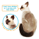 A plush Siamese cat toy shown on a white background, with a speech bubble reading 'I don't have whiskers so I can play with kids safely!' and a circular inset mentioning the foam face. The product is a soft stuffed cat with cream, tan, and dark brown fur.