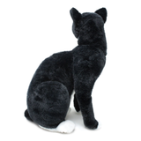 A black and white plush cat shown from the back.