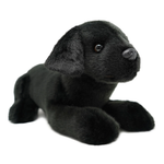 A black plush puppy toy with soft faux fur, realistic black eyes, and a black nose, posed lying down on a plain white background.