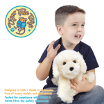 A young boy holding a white plush dog with safety text in the corner.