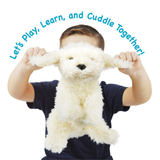 A child wearing a navy blue shirt holds up a fluffy white plush dog toy with floppy ears. Blue text curved over the top reads, 'Let's Play, Learn, and Cuddle Together!' on a plain white background.