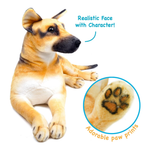 A plush dog toy with a realistic face and black nose, shown lying down on a white background. Blue text says 'Realistic Face with Character!' and there is a circular inset showing detailed brown paw prints with the text 'Adorable paw prints'.
