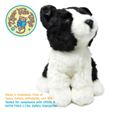 A black and white plush puppy toy sitting on a white background, with a circular 'Tiger Tale Toys' logo in the top left and safety text in the bottom left.