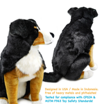 A plush dog toy shown from both front and back views on a white background, with text at the bottom stating it is designed in USA / Made in Indonesia, free of heavy metals and phthalates, and tested for compliance with CPSIA & ASTM F963 Toy Safety Standards.