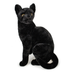 A black plush stuffed animal shaped like a sitting cat with yellow eyes, photographed on a plain white background.