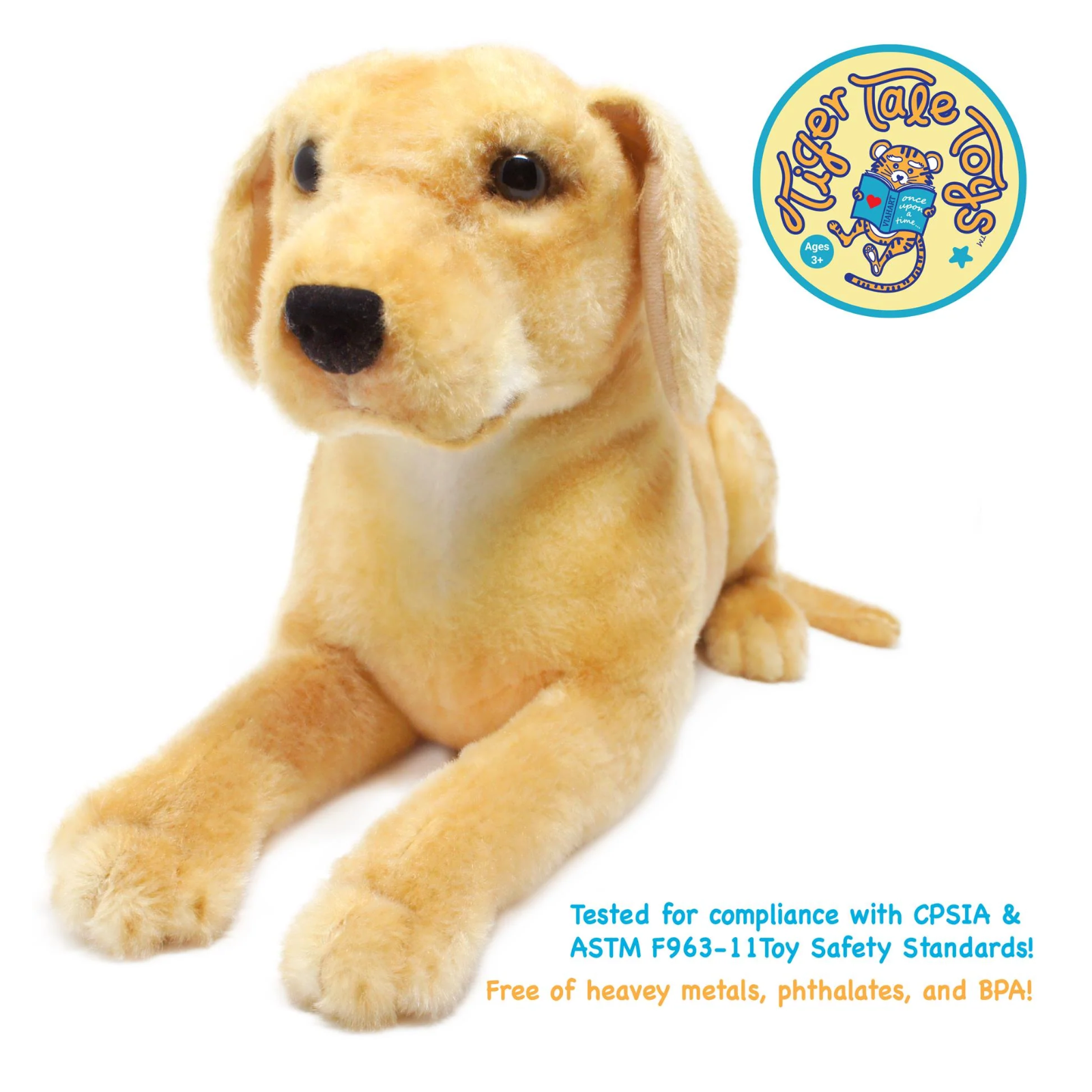 A plush yellow Labrador dog toy on a white background, featuring a circular 'Tiger Tale Toy' logo in the top right and safety certification text at the bottom.