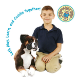 A young boy in a navy polo shirt and khaki pants sits on the floor next to a large brown and white plush dog toy, with the text 'Let's play, Learn, and Cuddle Together!' arched above them and a circular 'Tiger Hart Toys' logo in the top right corner.