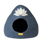 A triangular felt pet house in slate blue with a white lotus flower design on the front and a circular opening, featuring a small yellow Karma brand tag.