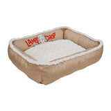 A tan rectangular pet bed with a white sherpa fleece lining and a white faux-fur trimmed edge. The brand name 'LAMB CHOP' is printed in red on the inner side wall next to a small lamb logo.