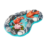 Felted toy pond with goldfish, stones, and a lily pad on a white background