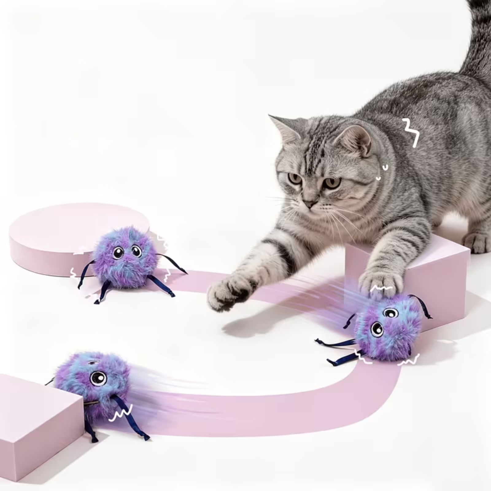 A gray tabby cat plays with three purple fluffy spider-shaped toys on a white studio background with pink geometric platforms.