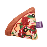 A plush dog toy shaped like a slice of pepperoni pizza, featuring a brown crust, beige cheese, red pepperoni slices, green leaves, and white mushrooms, with a purple brand tag reading 'Multipet'.