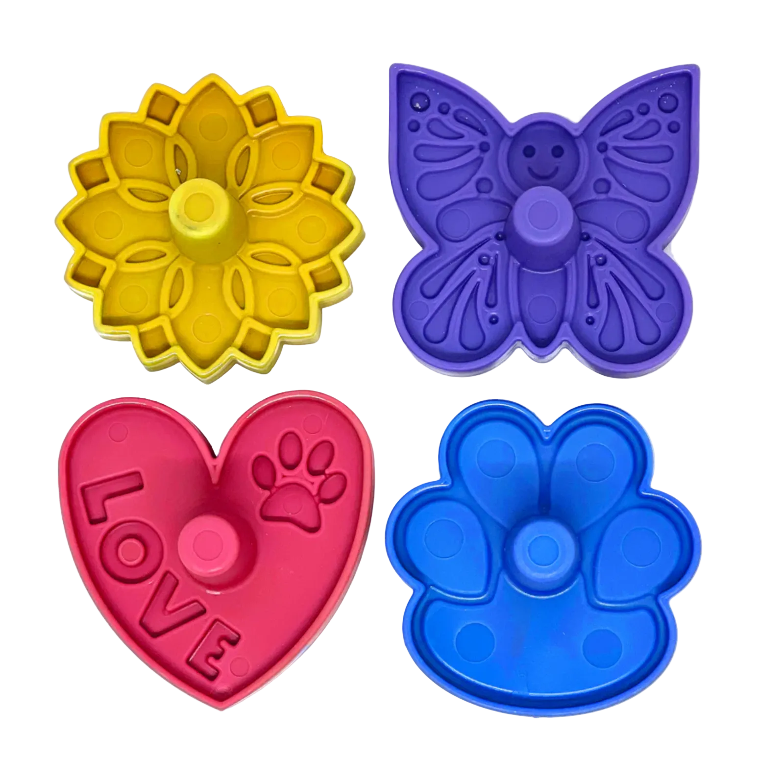 Four colorful plastic treat stoppers shaped like a yellow flower, purple butterfly, pink heart with 'LOVE' and paw print, and a blue paw print, arranged on a white background.
