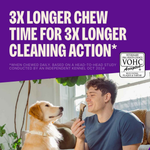 Man holding a dog chew treat with a dog sitting next to him, on a purple background with text about chew time and cleaning action.