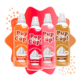 Four Pup Cup! whipped treat cans arranged in a fan shape on a white background with orange and red abstract shapes. The cans are labeled Pumpkin Flavor, Original, Bacon Flavor, and Peanut Butter Flavor.