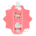 A bottle of Pup Cup! whipped dog treats in Bacon Flavor, shown against a white background with a pink splash graphic behind it. The bottle is white with red and brown lettering and features an illustration of a dog on the logo.