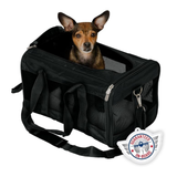 A small brown and white dog sits inside a black pet carrier bag with mesh side panels and a shoulder strap, shown on a white background. A circular badge reading 'Guaranteed On-Board' is overlaid near the bottom right.