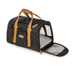 A black pet carrier duffel bag with tan handles and straps, shown with its front door open to reveal a gray interior. The bag has a textured black fabric body and gold-tone hardware.