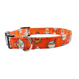 An orange dog collar with a repeating pattern of coffee cups, mugs, and a donut, featuring a black buckle and silver metal ring.