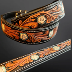 Decorative leather belt with floral patterns on a dark background