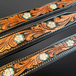 Decorative leather straps with floral patterns on a dark background