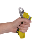 A hand gripping a yellow webbed climbing or safety strap with a silver metal carabiner and black plastic buckle, shown against a plain white background.