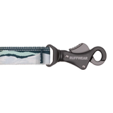 A close-up of a Ruffwear lanyard with a dark gray metal clip and a patterned webbing strap in shades of teal, white, and gray.