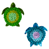 Two sea turtle plush toys, one green and one blue with a purple center, on a white background