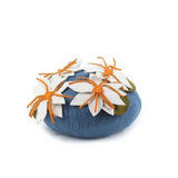 A dark blue felt pet cave with white and orange flowers with green leaves on the top seen from the top and displayed on a white background. 